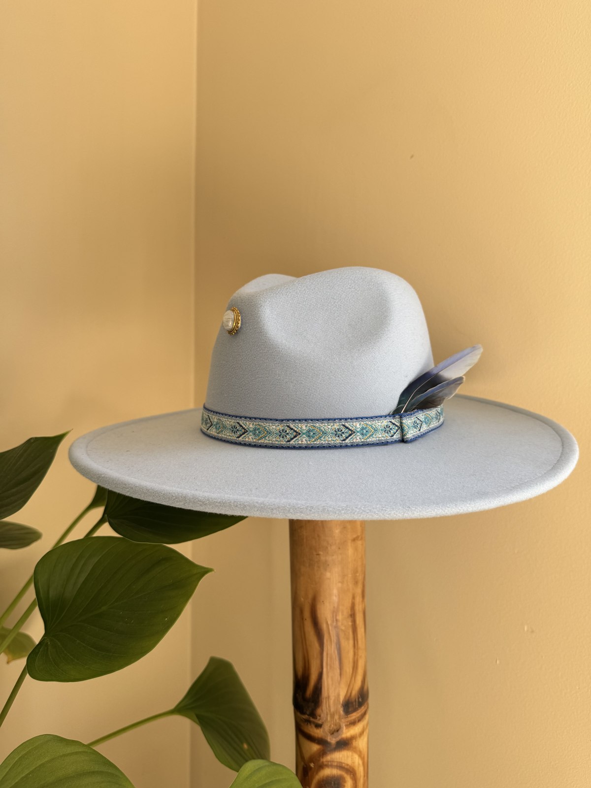 Pale blue fedora with woven diamond band and feather