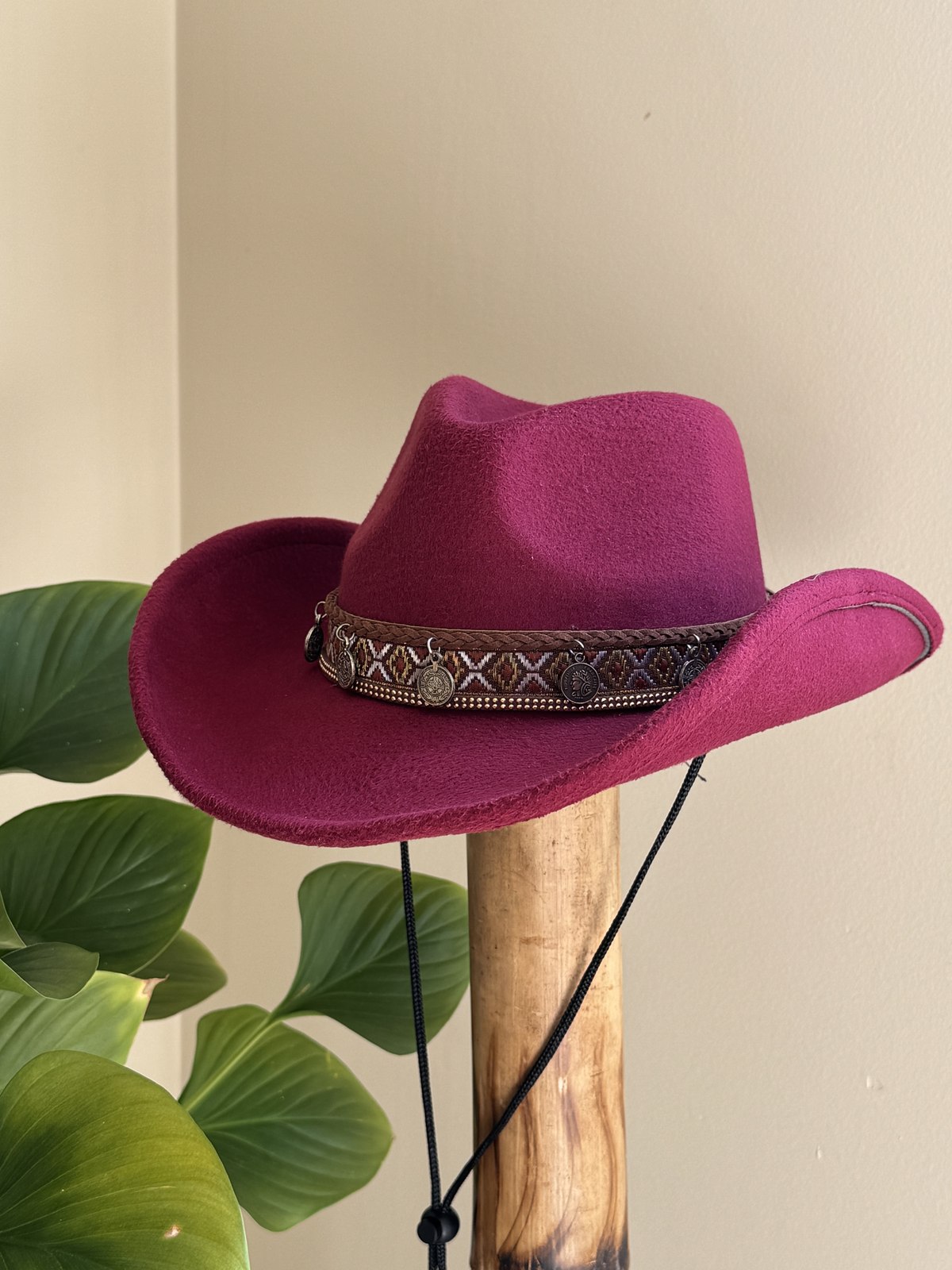 Burgundy western hat with braided band and bronze charms