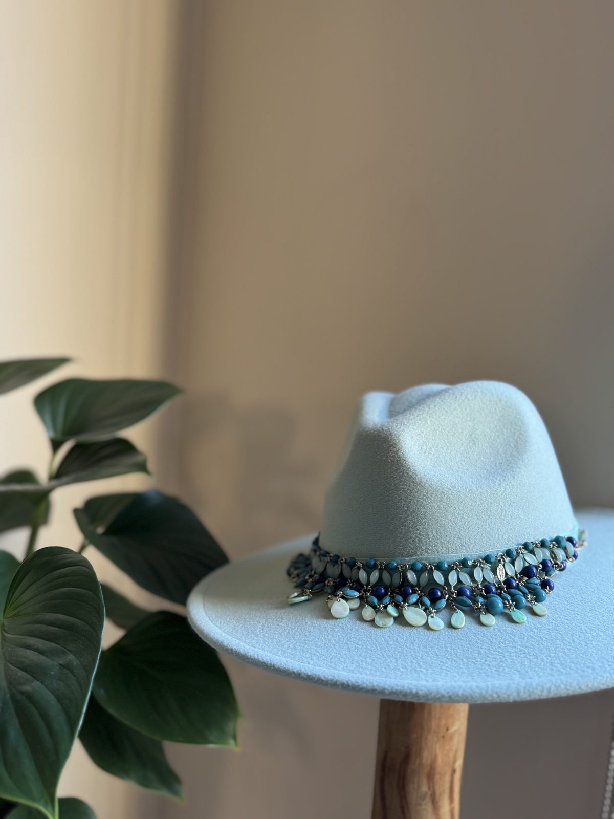 Sky blue fedora with dark beaded feathered band