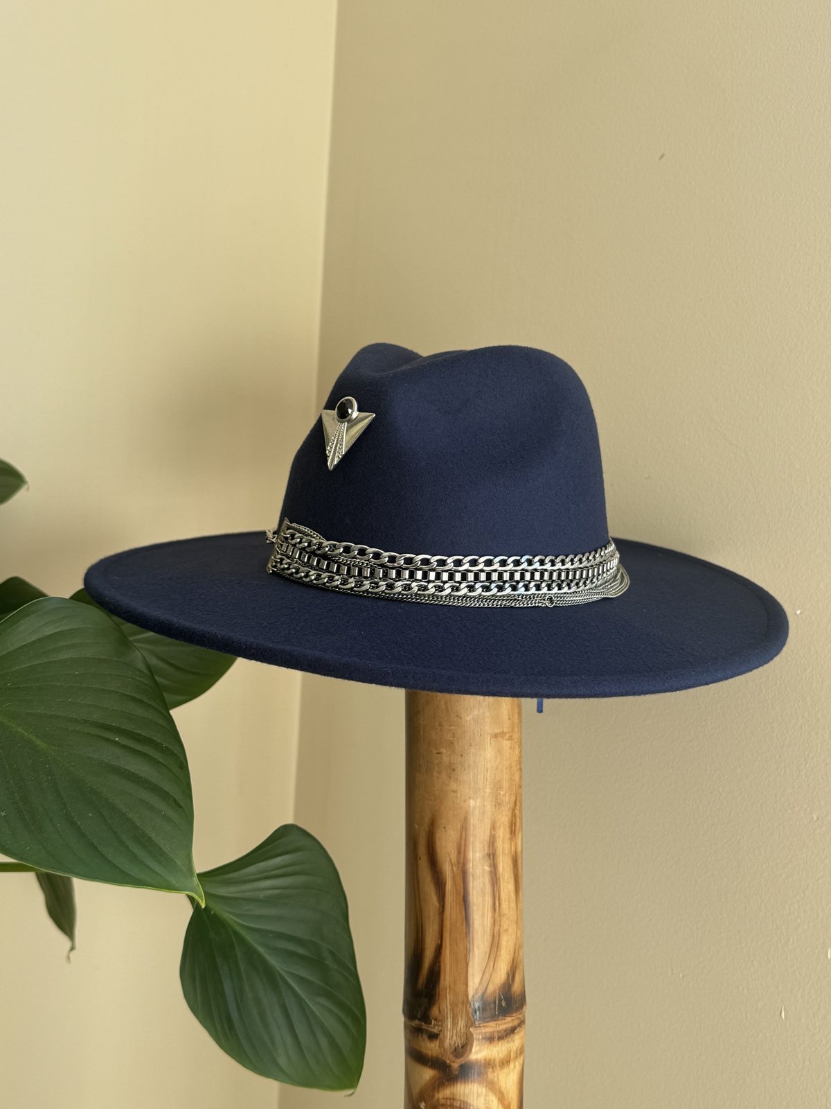 Navy fedora with ornate silver pin