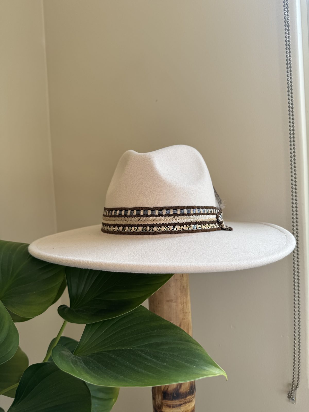 White fedora with feather and dark band