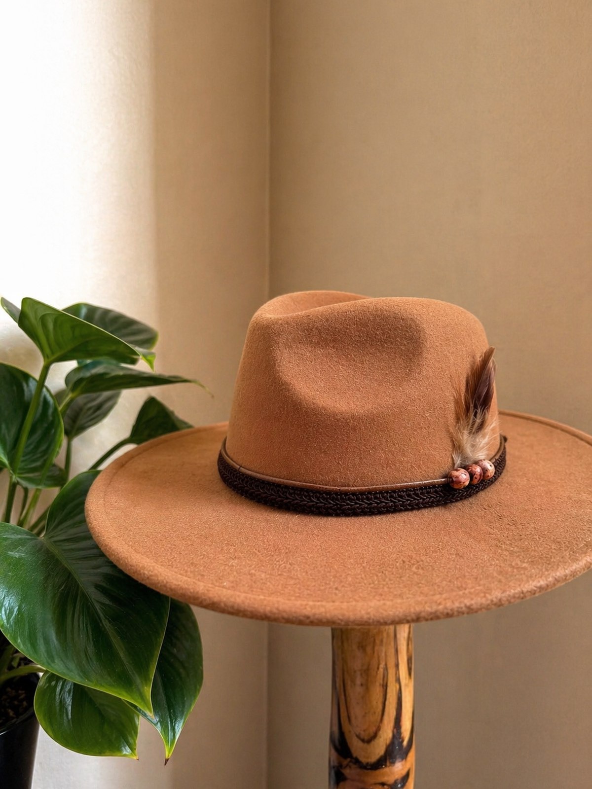 Camel fedora with braided band, beaded charms and feather