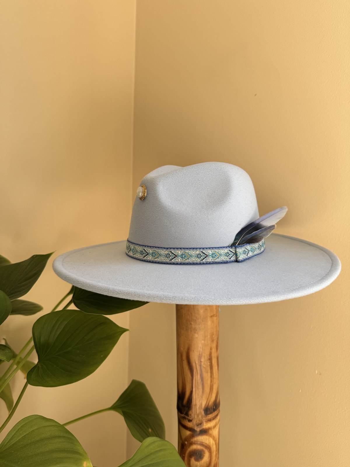 Pale blue fedora with woven diamond band and feather