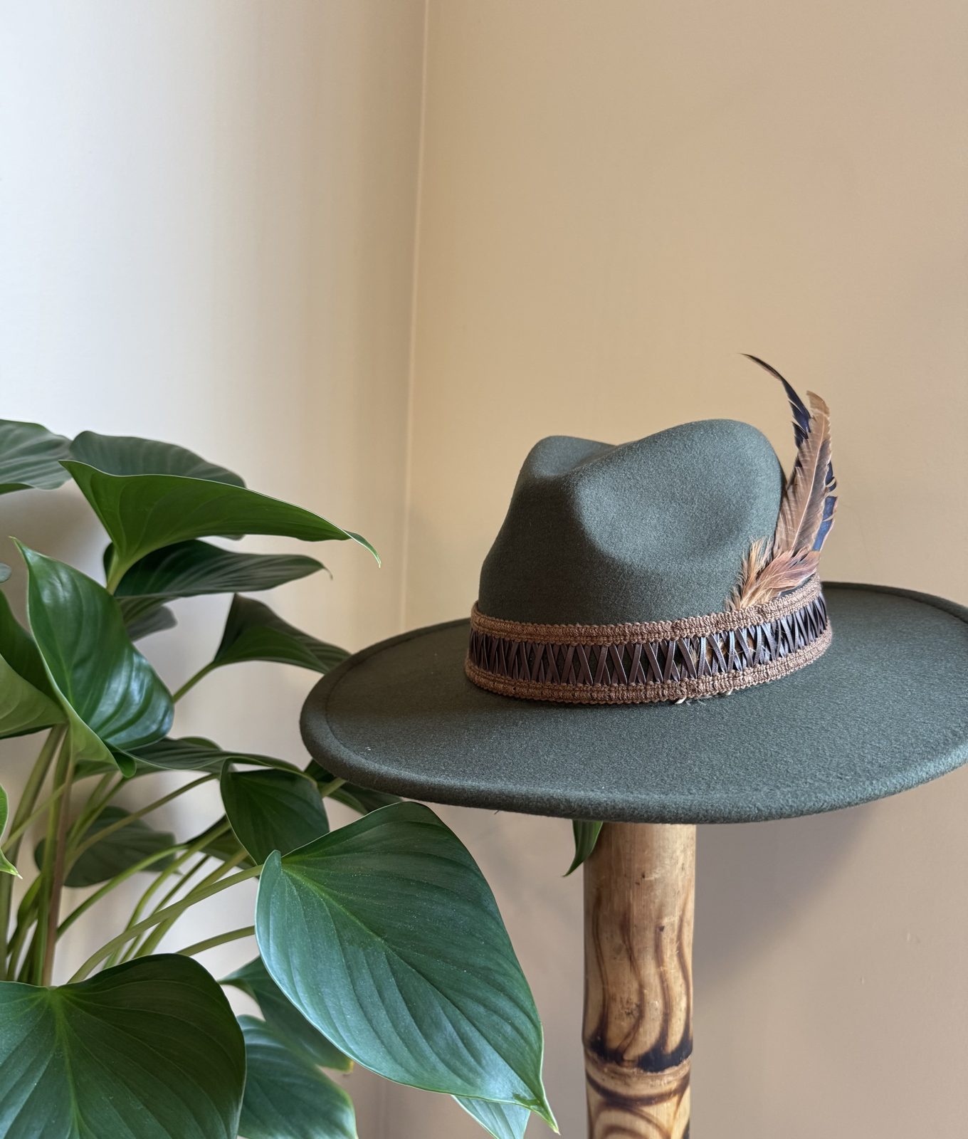 Hunter green fedora with feather and leather band