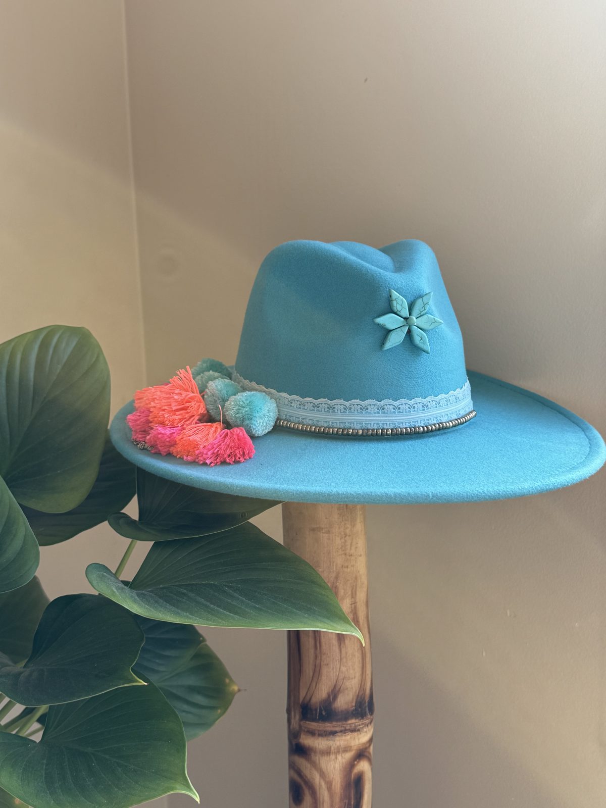 Teal fedora with flower and coral pompom
