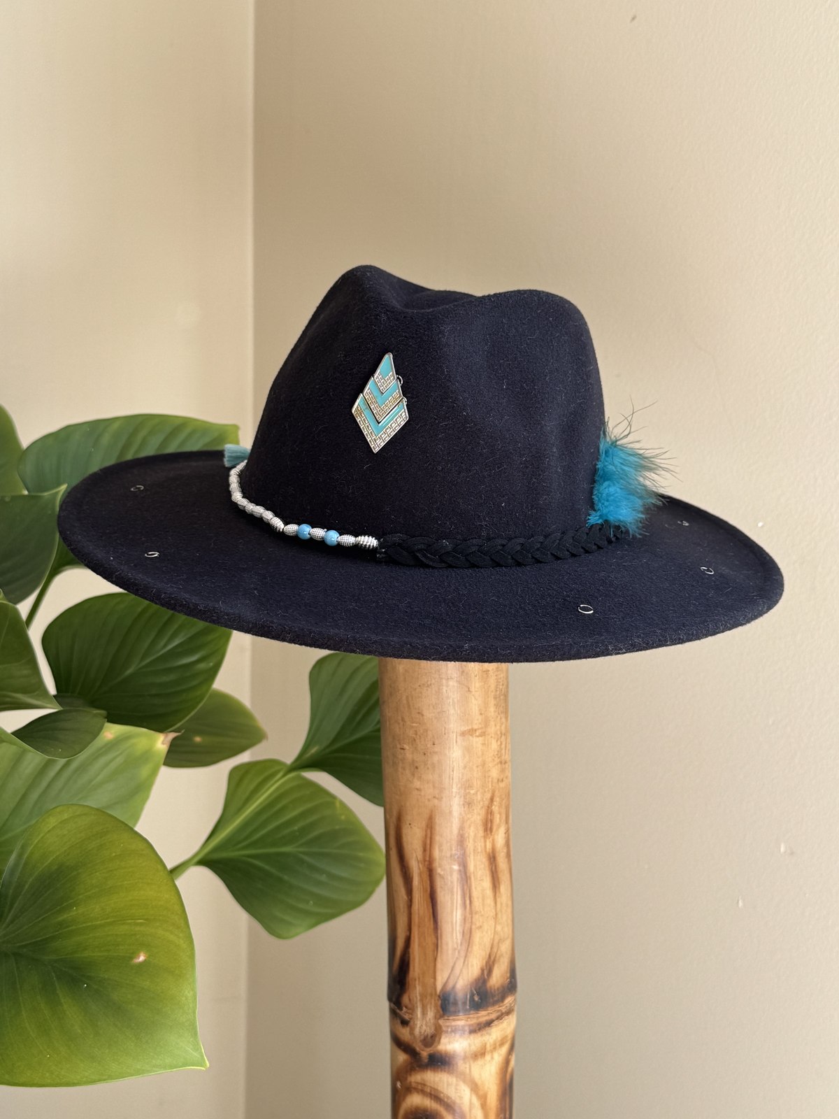 Brown western hat with pearl beaded band and yin-yang pendant