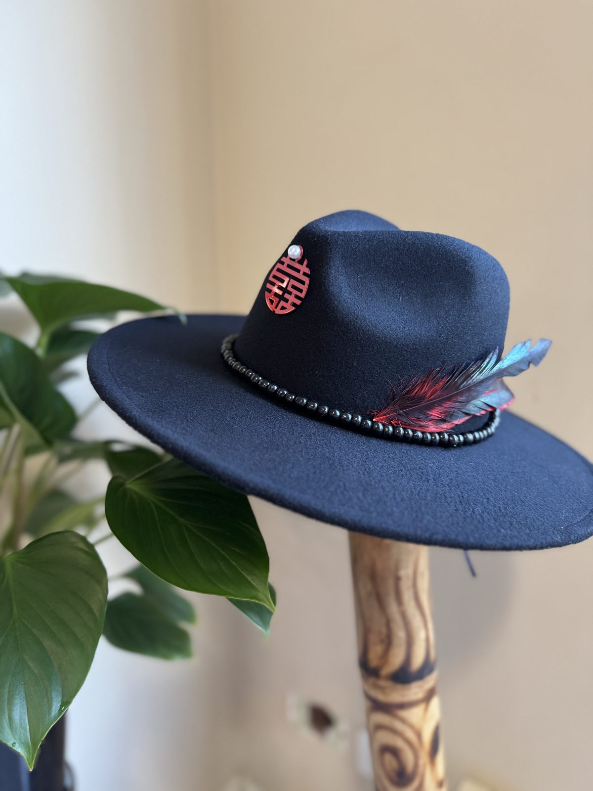 Navy fedora with red pendant and feather
