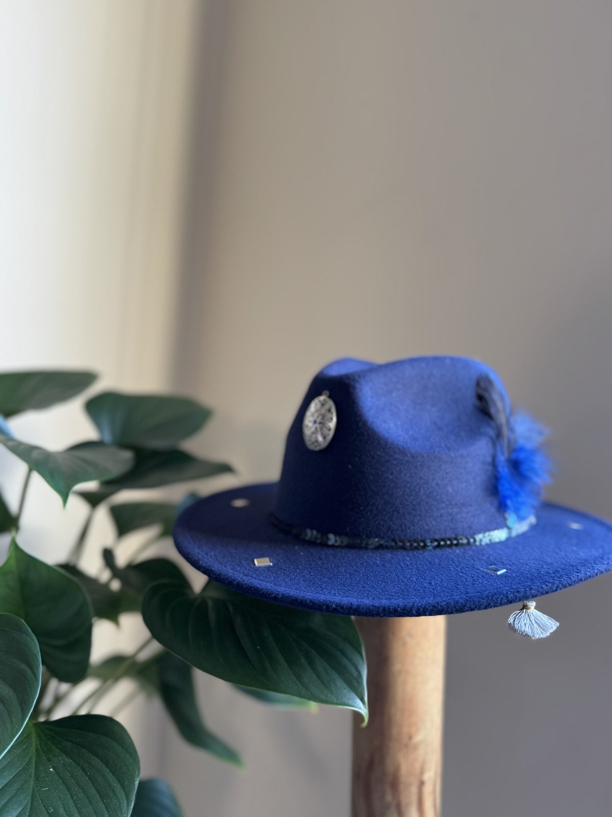Navy fedora with blue pompom and silver disc