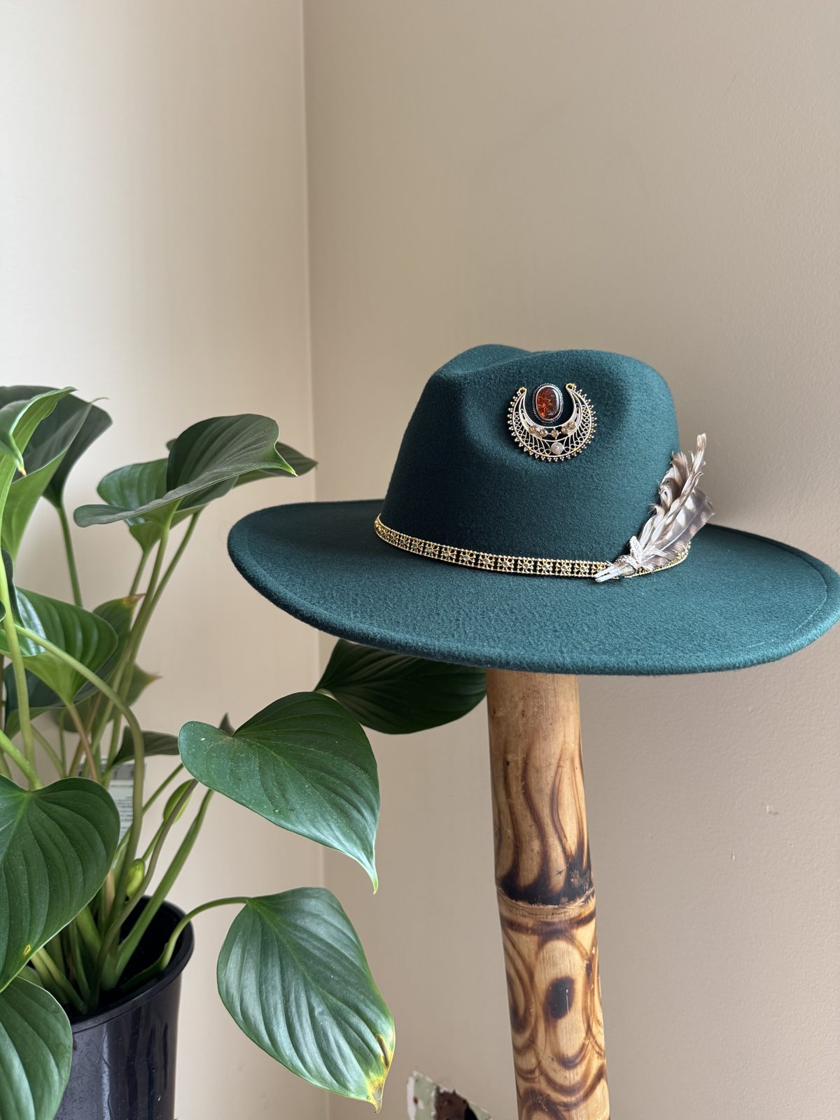 Forest green fedora with ornate silver pin
