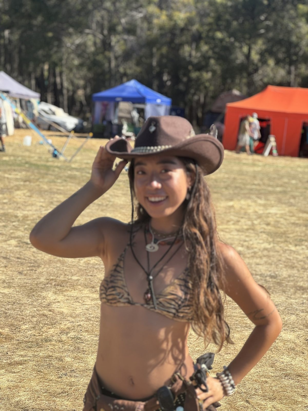 Woman wearing dark cowboy hat at a festival