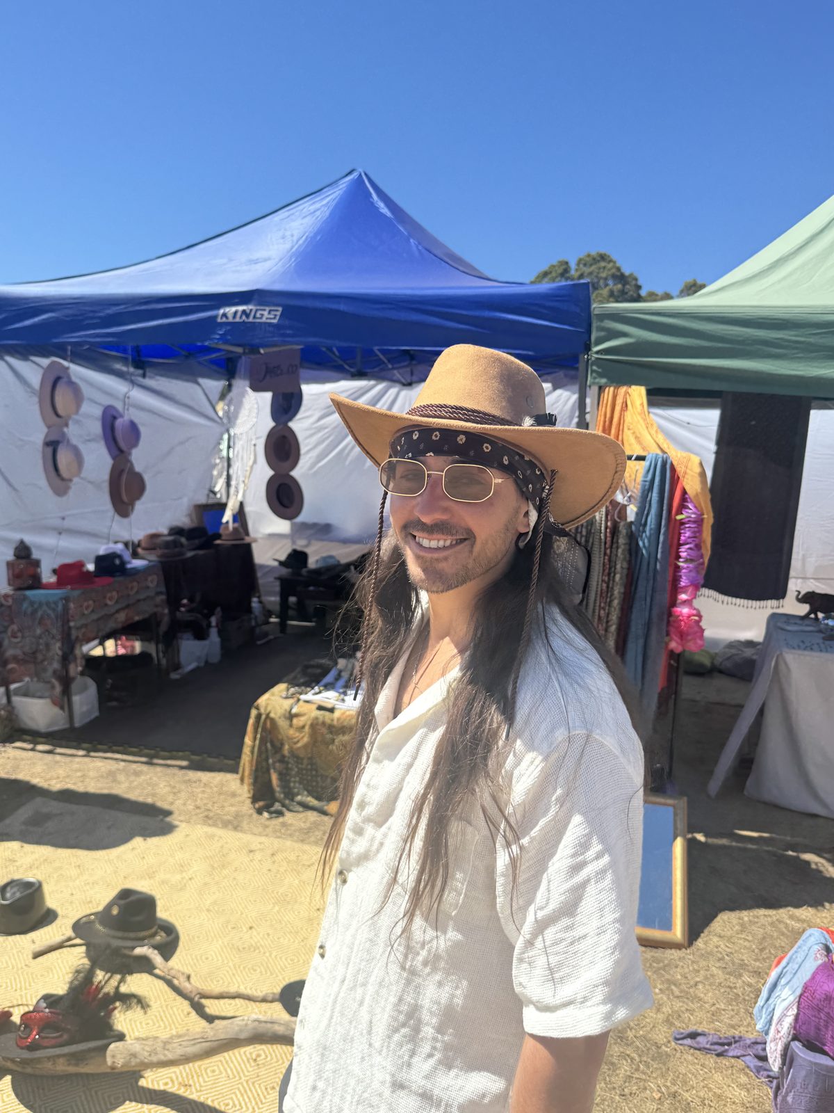 Person at a festival wearing a colourful outfit and hat